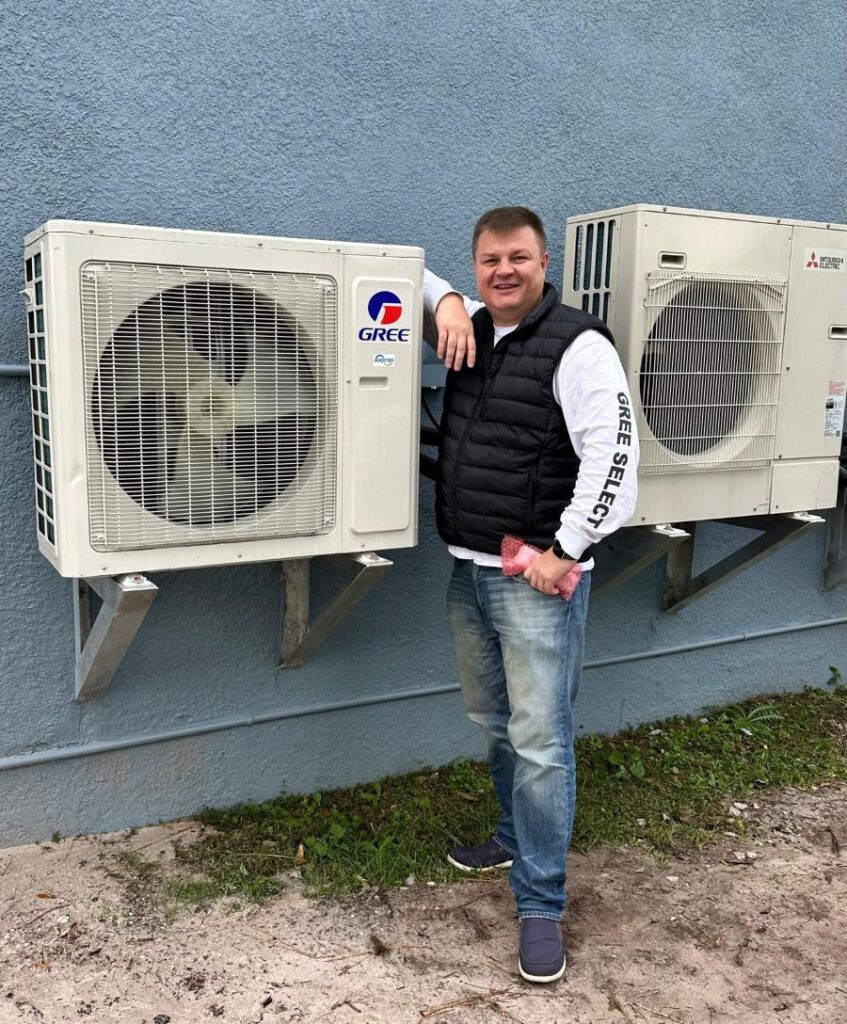 Tech standing next to ac unit